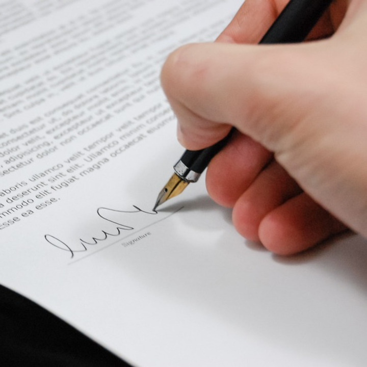 Stock image of signing a document